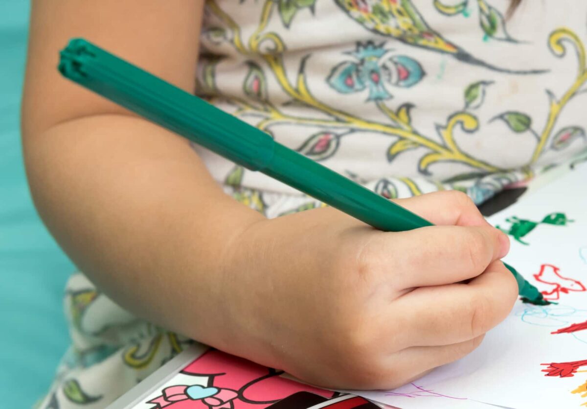 A young girl writing in a journal. 