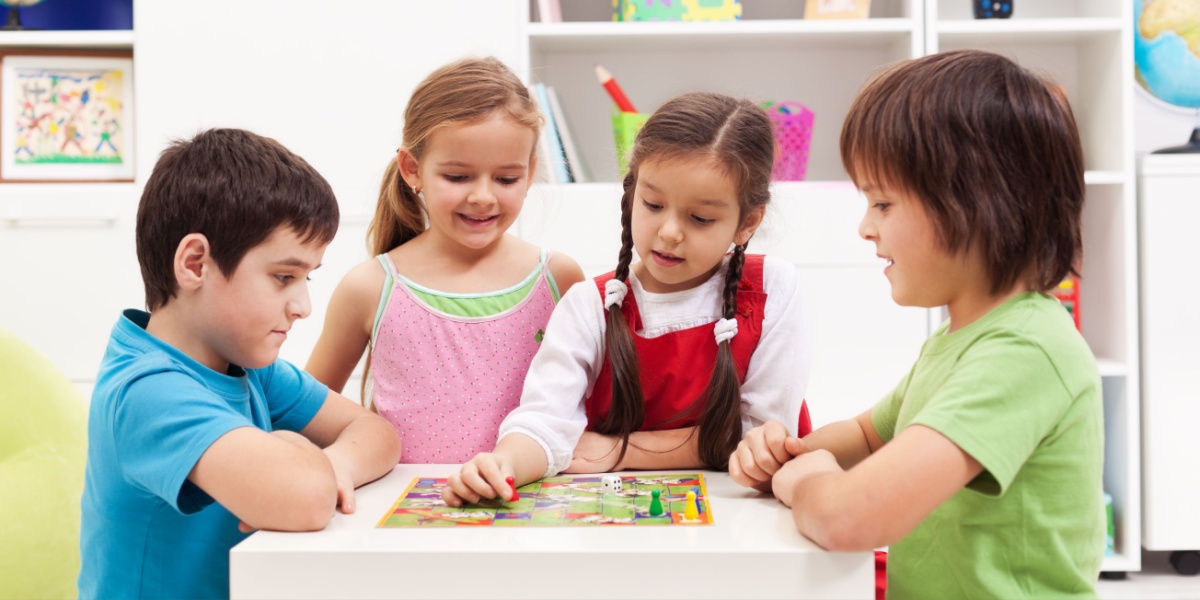 Children in a circle together playing a game in cooperative play. 