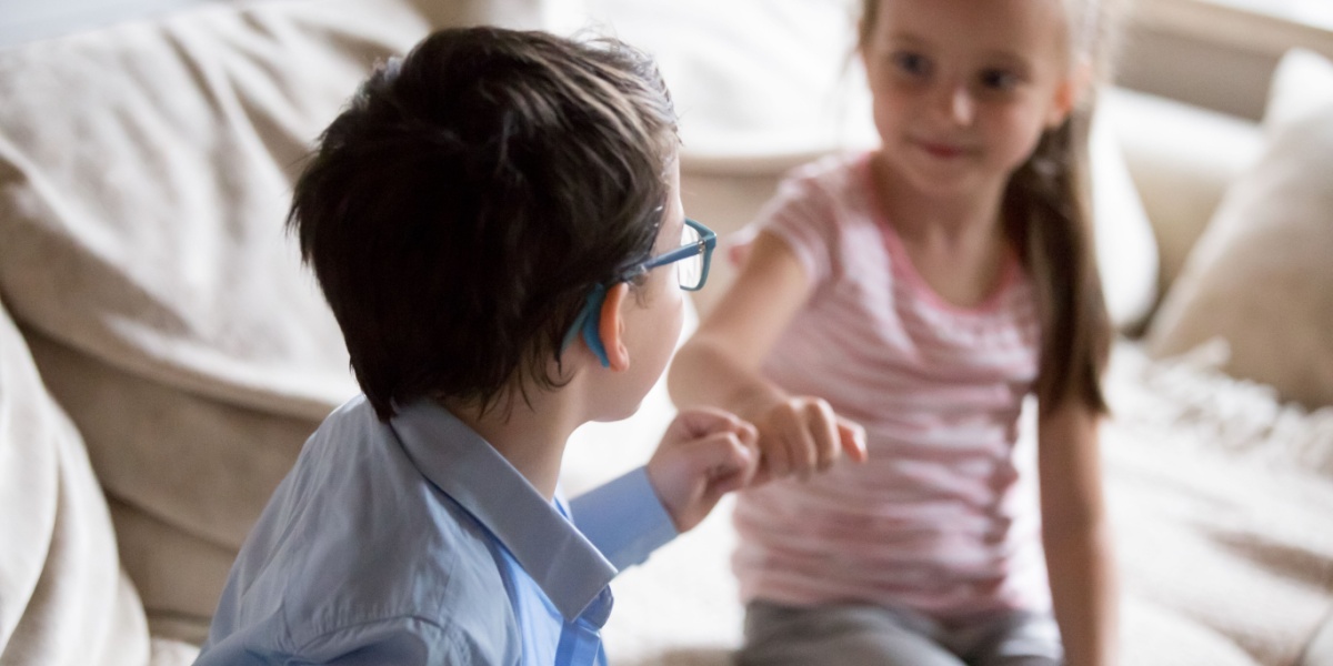 Two kids giving each other a fist bump. 
