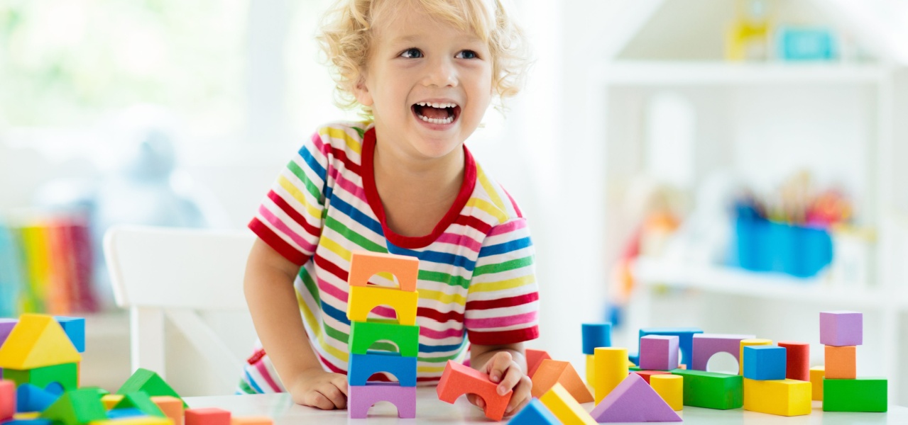 A young child playing with blocks in a fun pattern activity game. 