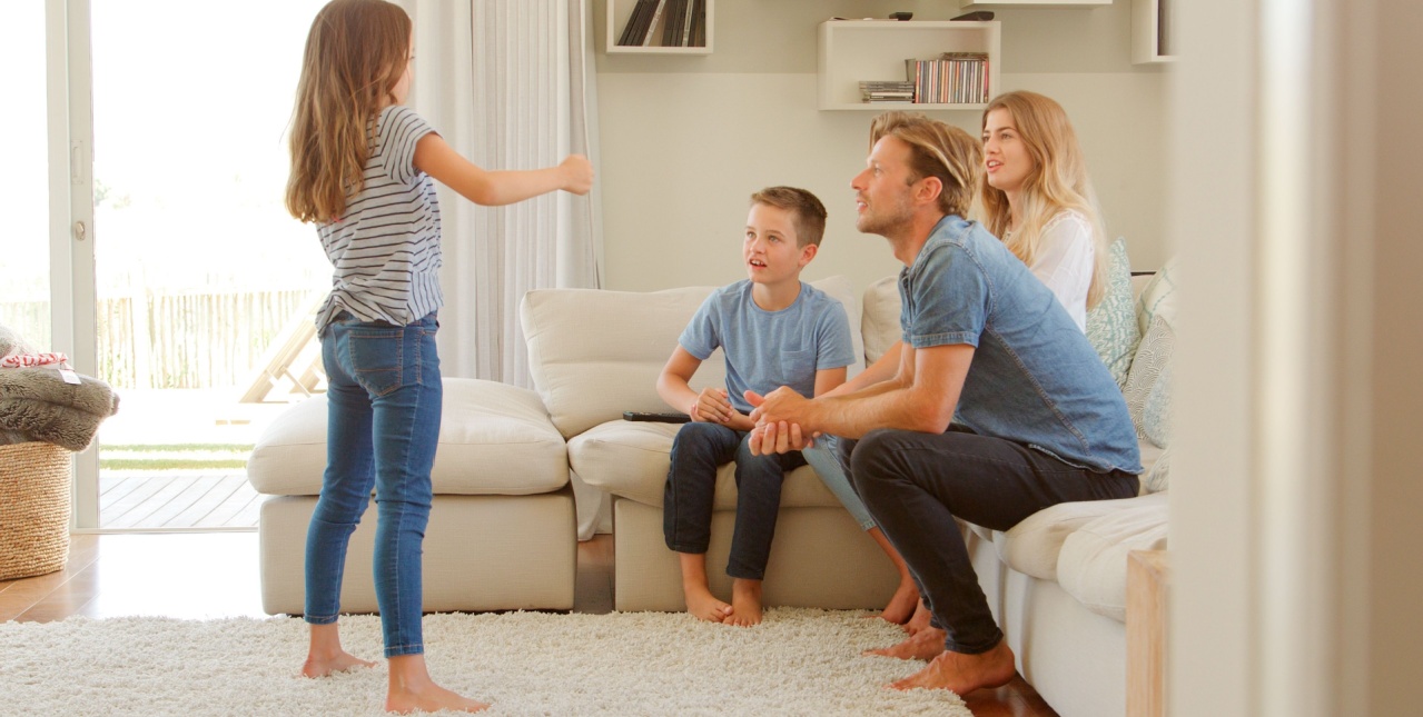 Family playing charades together. 