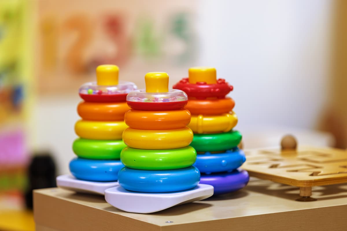 Three stackable toys sitting side by side. 