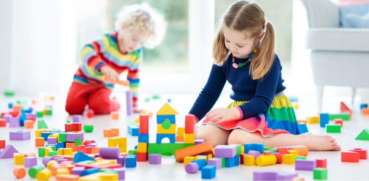 Two young children engaging in parallel play. 