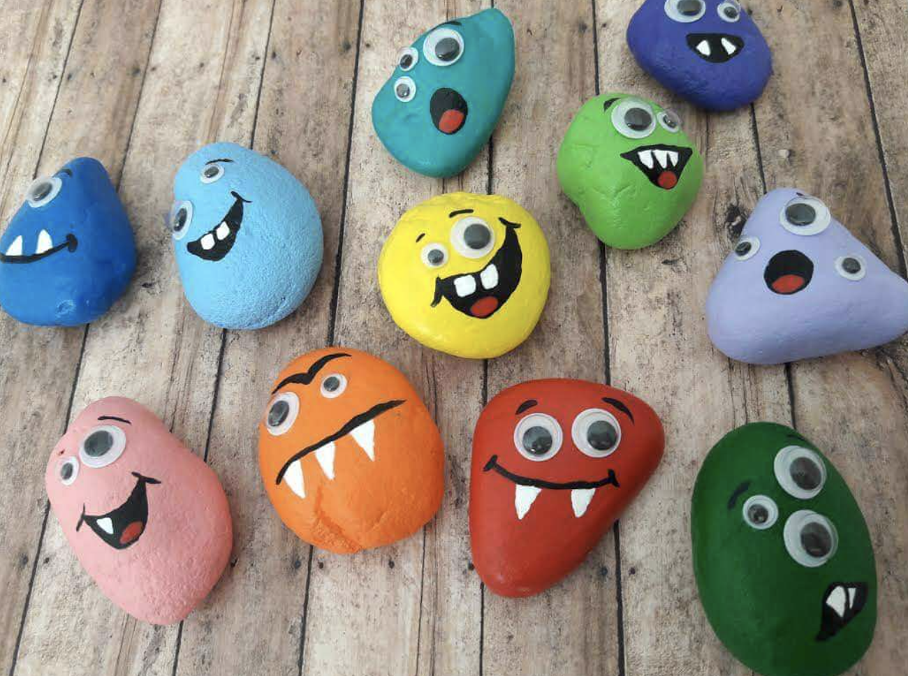 Cute little monster rocks painted for a fun Halloween craft activity. 