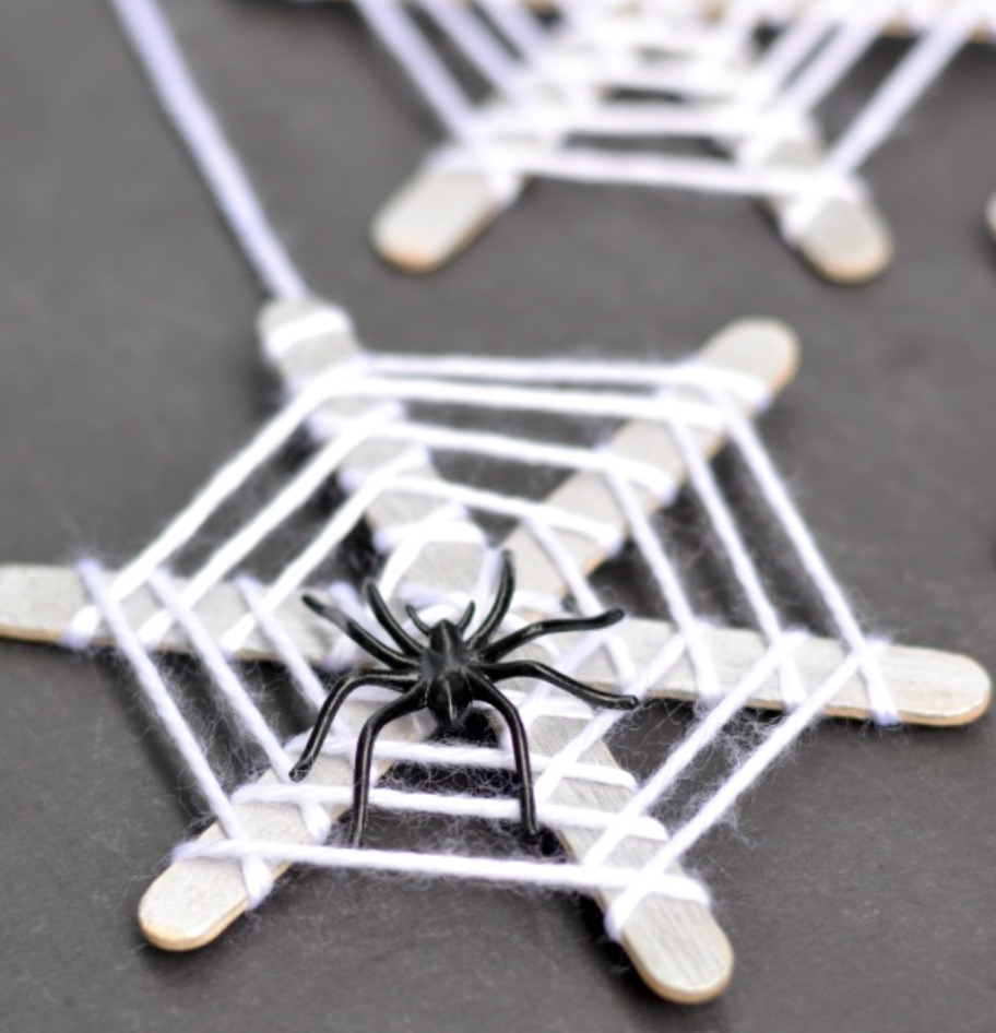 Fun simple spider web yarn and stick craft for kids to do on Halloween. 