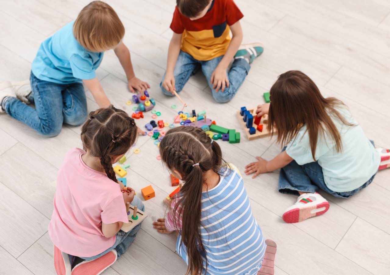 Children on floor with puzzles and blocks