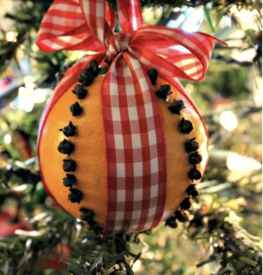 An orange made into a Christmas ornament. 