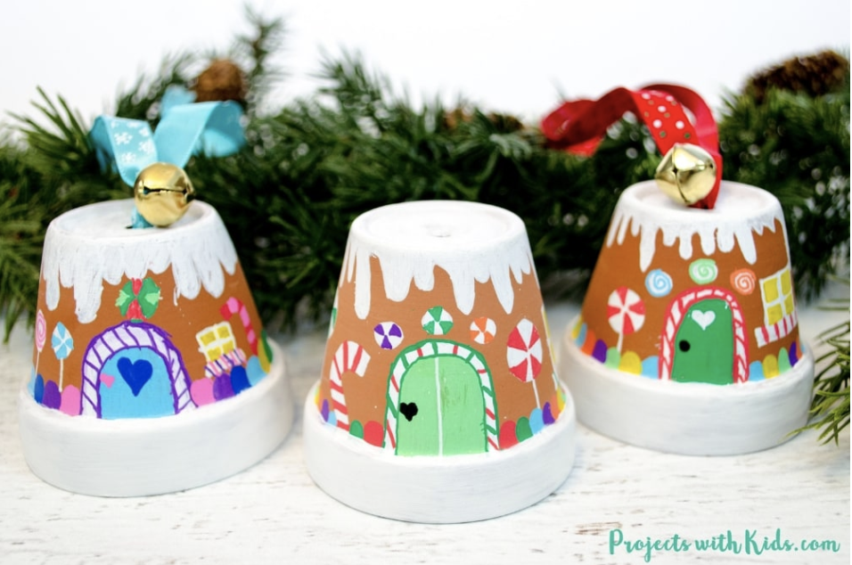 Cute pots painted with colorful paint to make little gingerbread houses. 