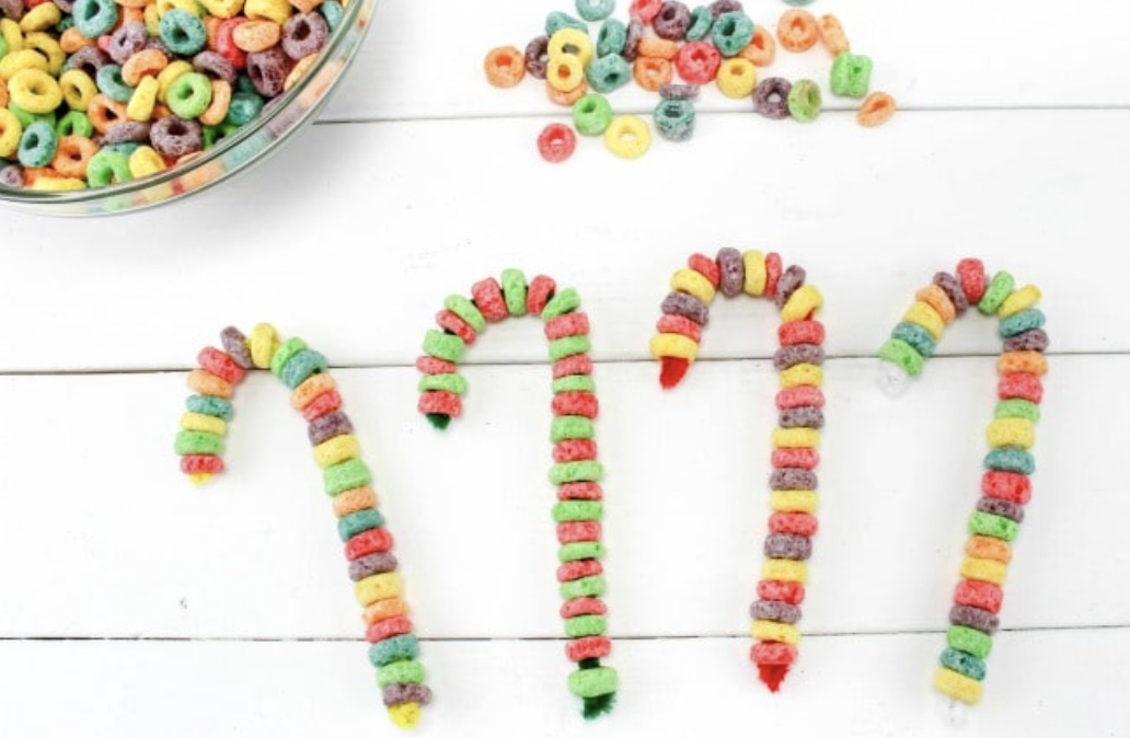 Candy canes made from fruit loops fun edible Christmas craft for kids. 