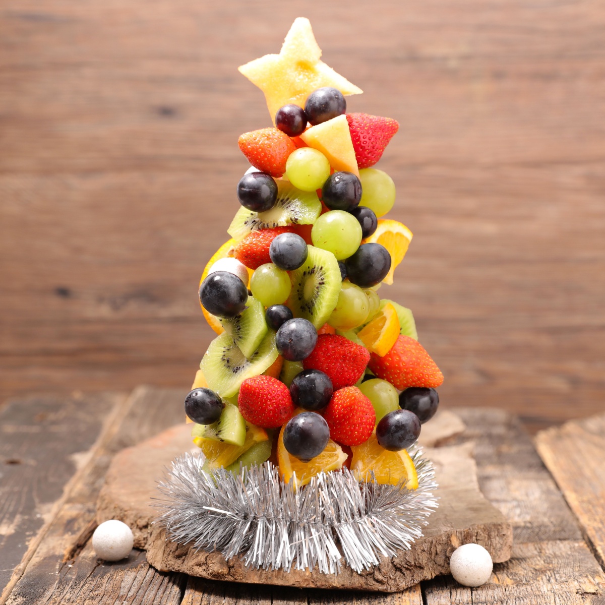 A Christmas tree made from fruit, fun edible holiday craft for kids. 
