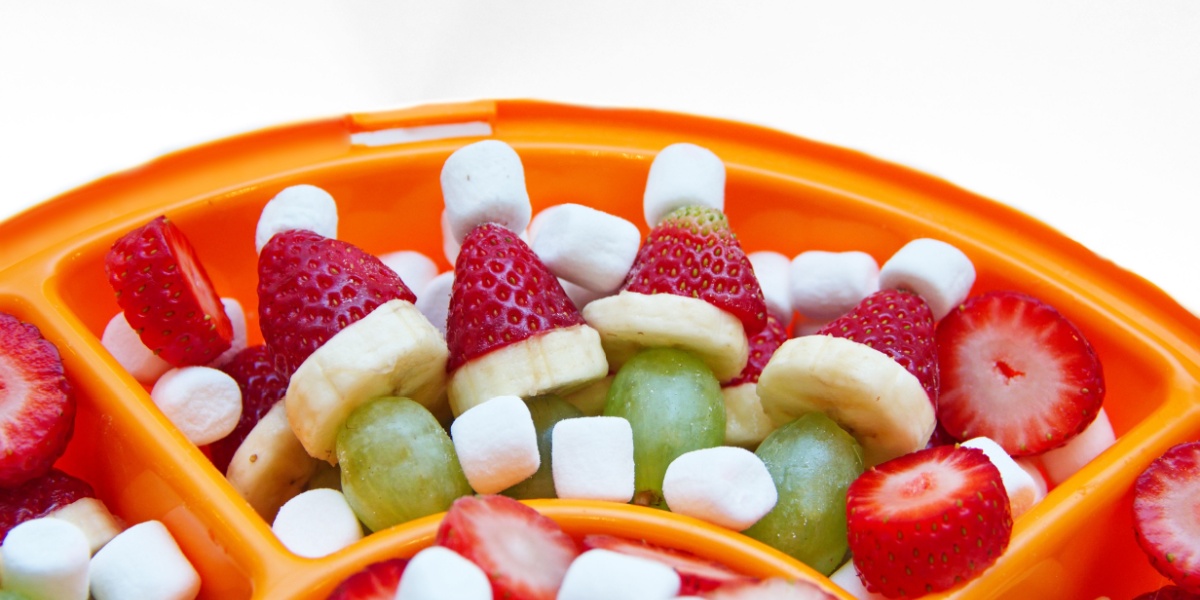 Cute little grinch kabobs made from strawberries bananas grapes and marshmallows. 