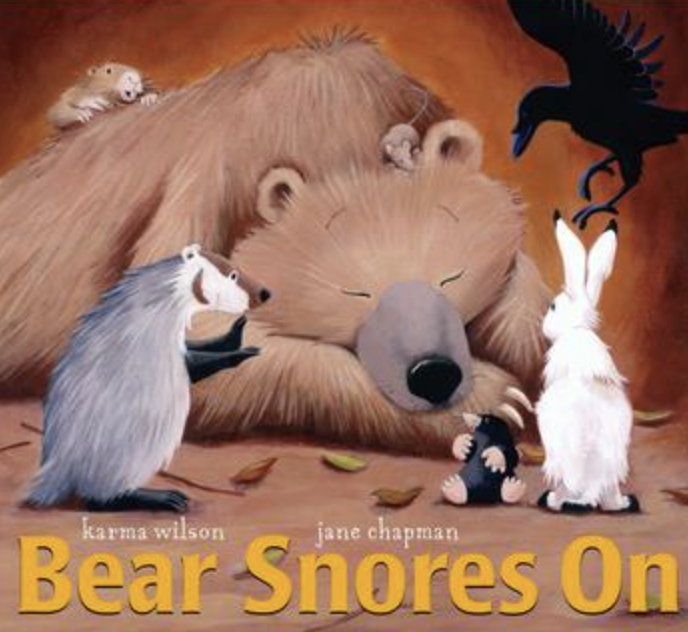 Illustrated book cover showing a large sleeping bear in a cozy cave while woodland animals gather quietly around him.