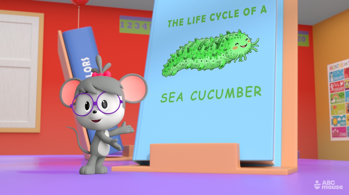 An animated mouse character stands beside a classroom poster about the life cycle of a sea cucumber.