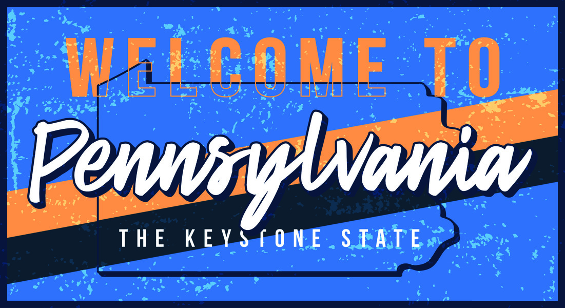 Bold decorative sign reading 'Welcome to Pennsylvania' with 'The Keystone State' subtitle on a blue distressed background.