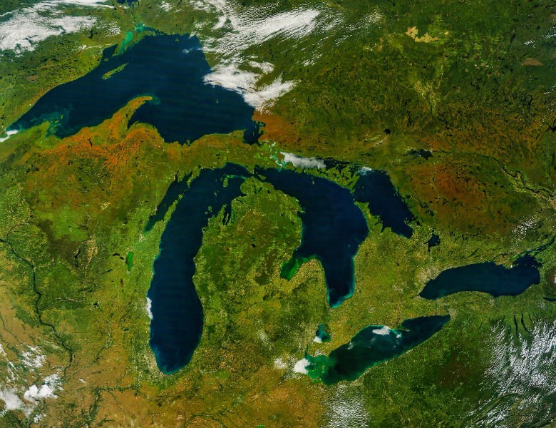 Satellite view of the Great Lakes region with Lakes Superior, Michigan, Huron, Erie, and Ontario and surrounding green land.
