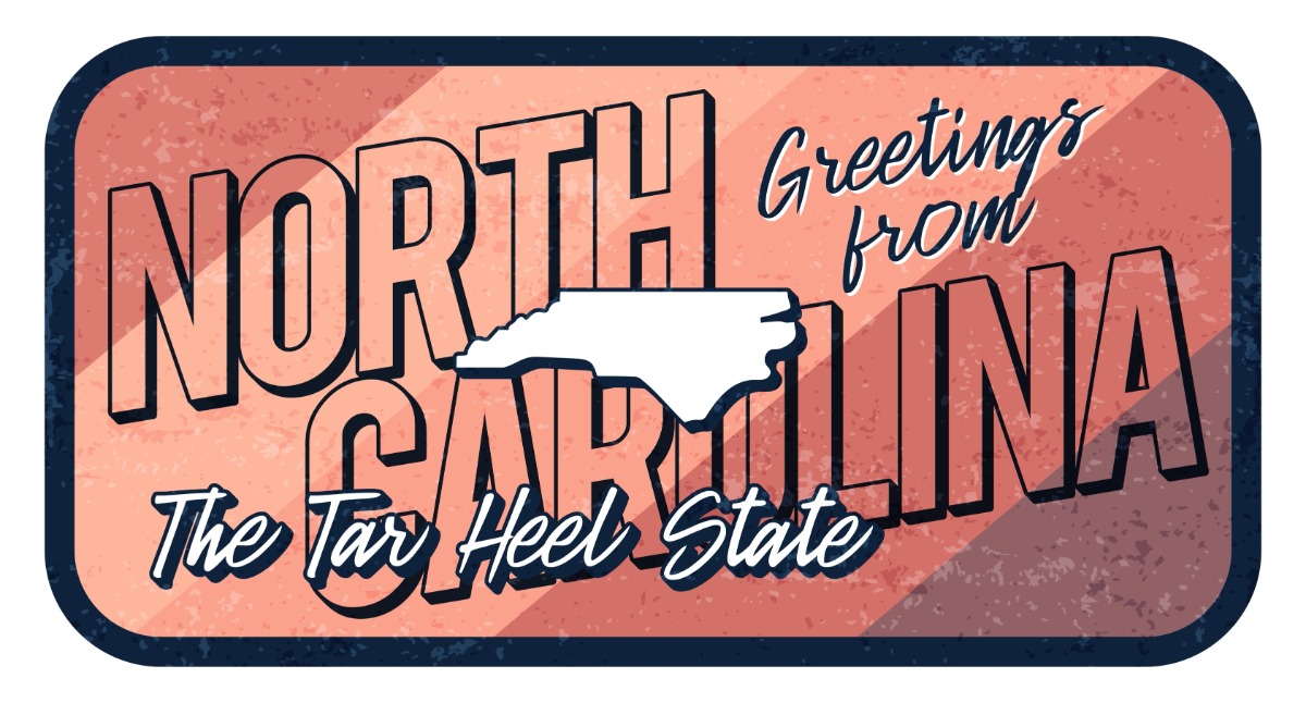 Retro postcard-style graphic reading 'Greetings from North Carolina' with a large 'NORTH CAROLINA' backdrop and a white outline of the state, captioned 'The Tar Heel State'.