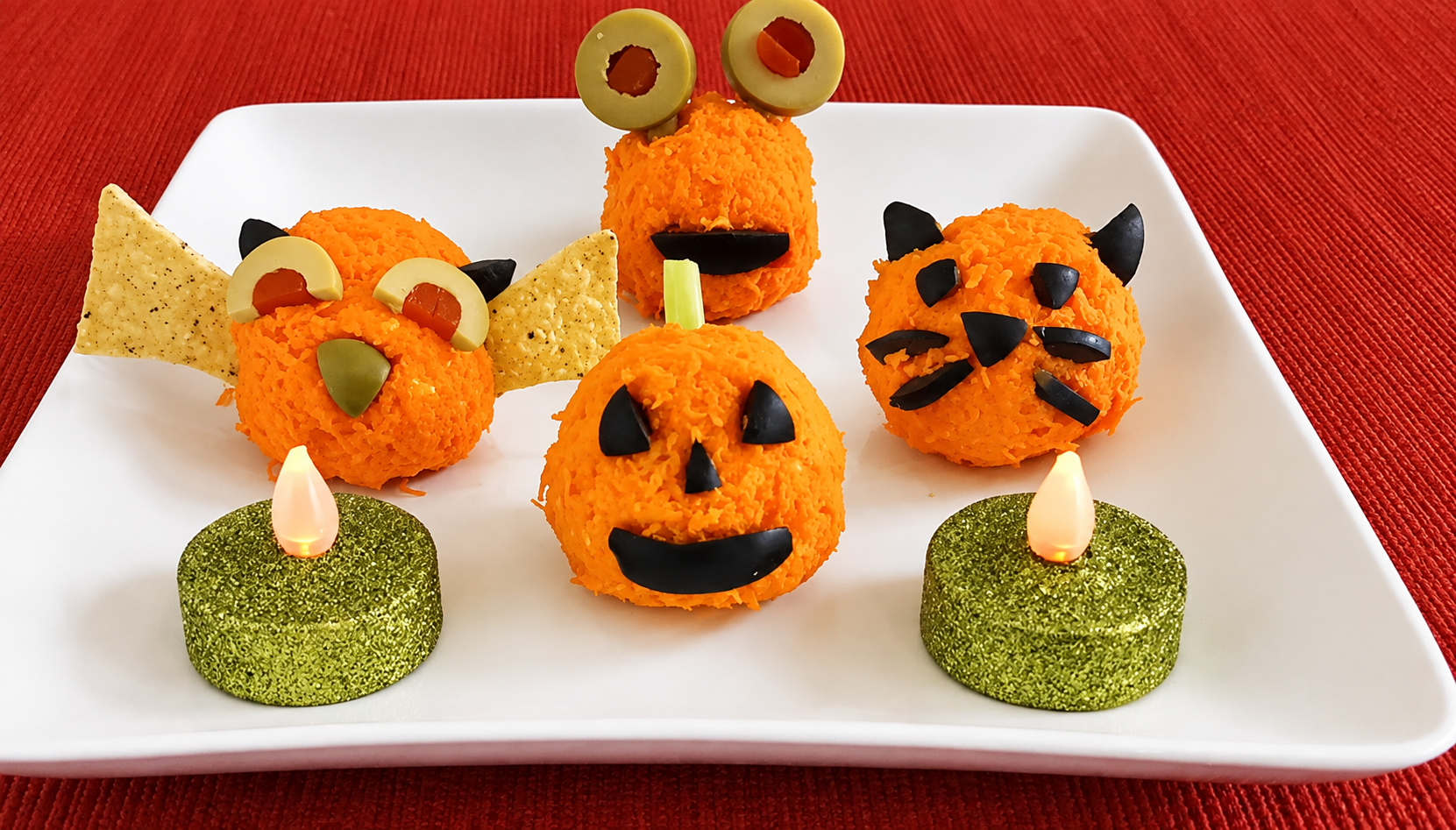 Halloween Rice Krispie treats decorated as orange pumpkins, monsters, and black cats.